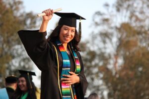 woman holding her diploma during her graduation